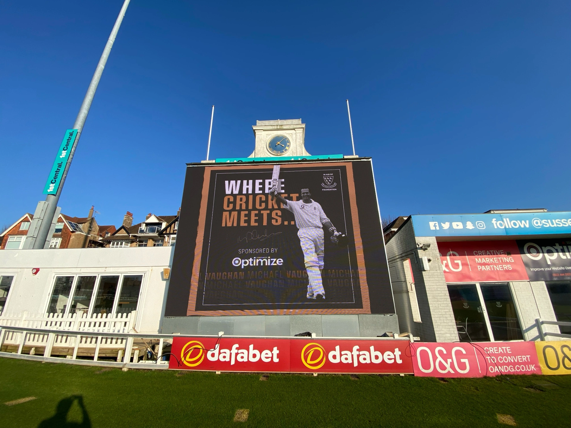 Brighton Cricket — front elevation of LED scoreboard displaying Michael Vaughan branded sponsorship content beneath the pavilion clock tower