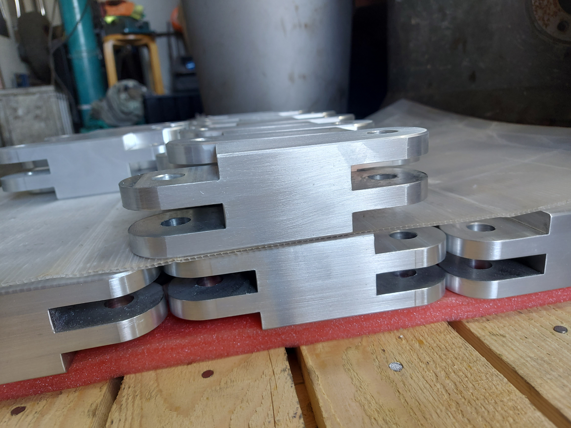 Forming Tools — finished machined link plates produced from the bespoke tooling, batched and protected