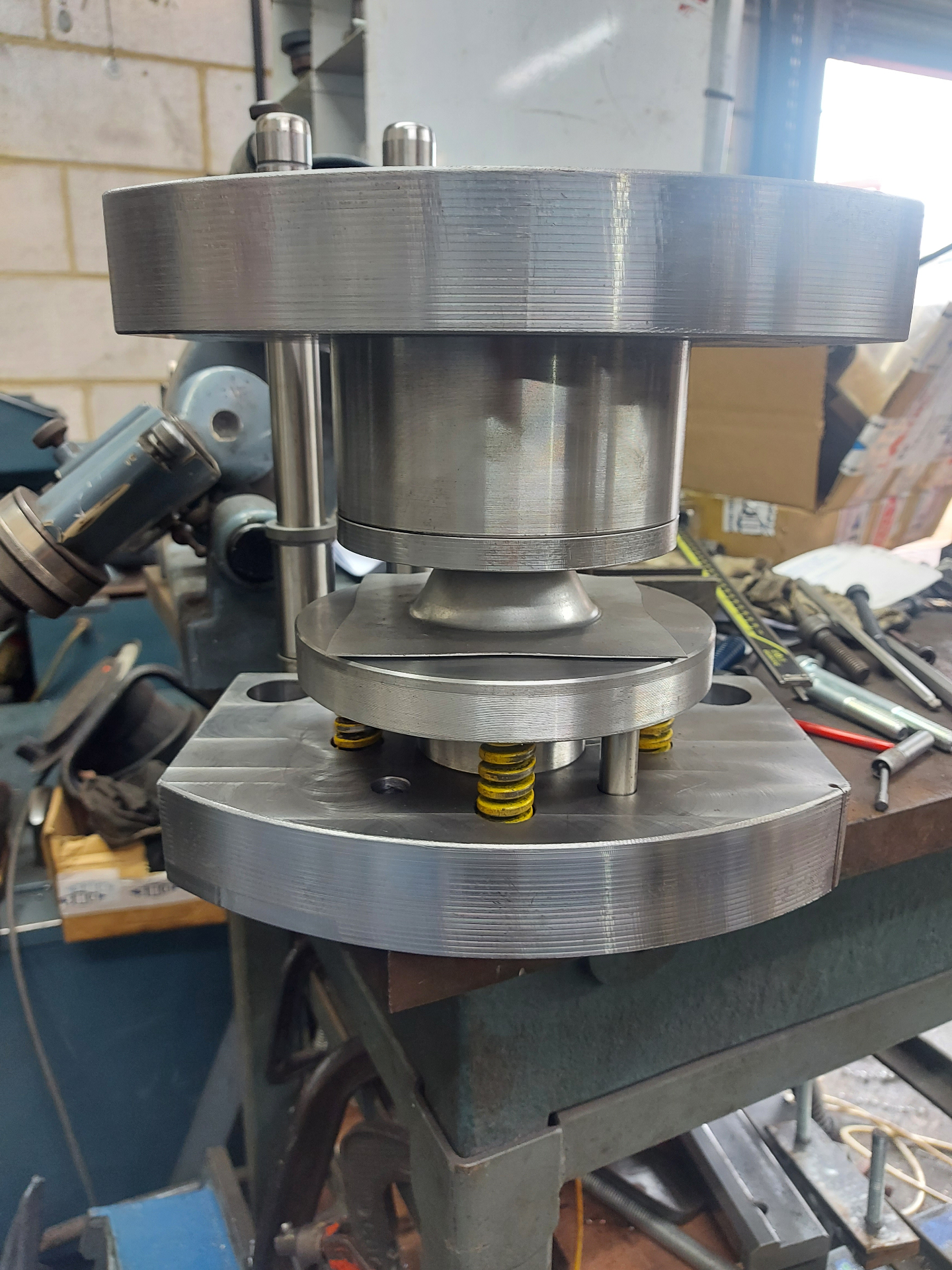Forming Tools — bespoke press tool stack on bench, sprung lower die with upper punch loaded
