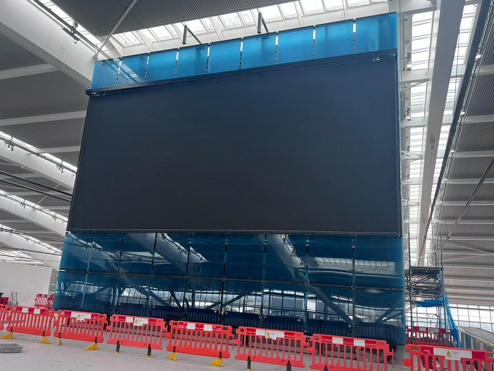 Heathrow Terminal 5 — installed large-format LED screen suspended from terminal roof structure