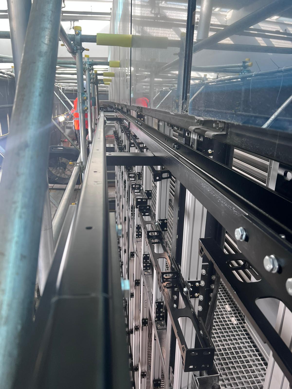 Heathrow Terminal 5 — bespoke aluminium rigging frame and bracket assembly behind LED wall