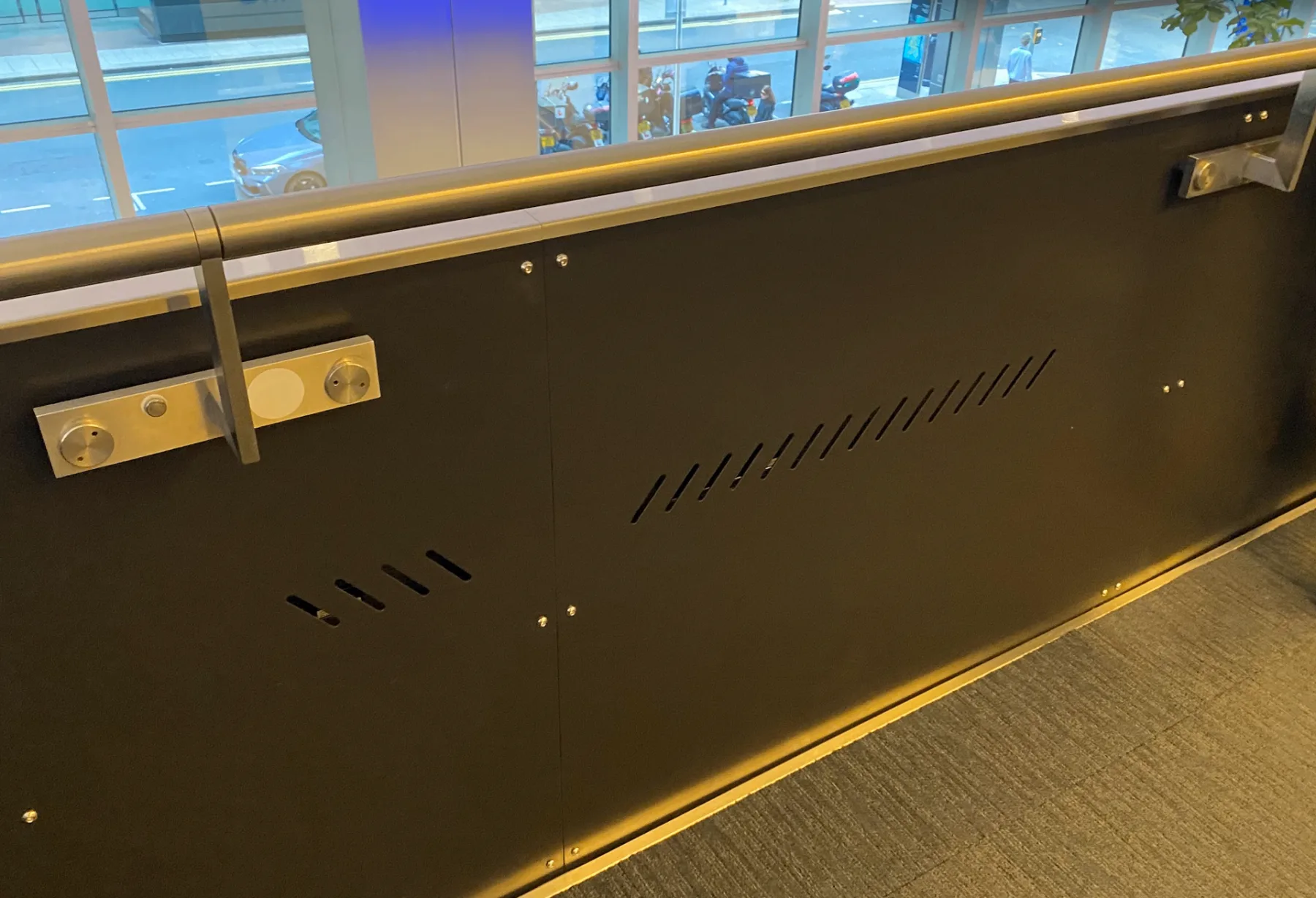 KPMG — bespoke balustrade panel with laser-cut vent detail and stainless bracketry