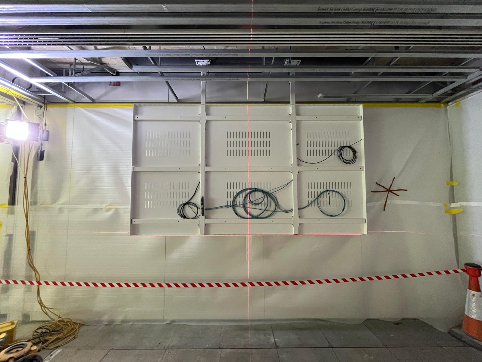 Madrid — bespoke bracket array set out with laser alignment during structural install phase