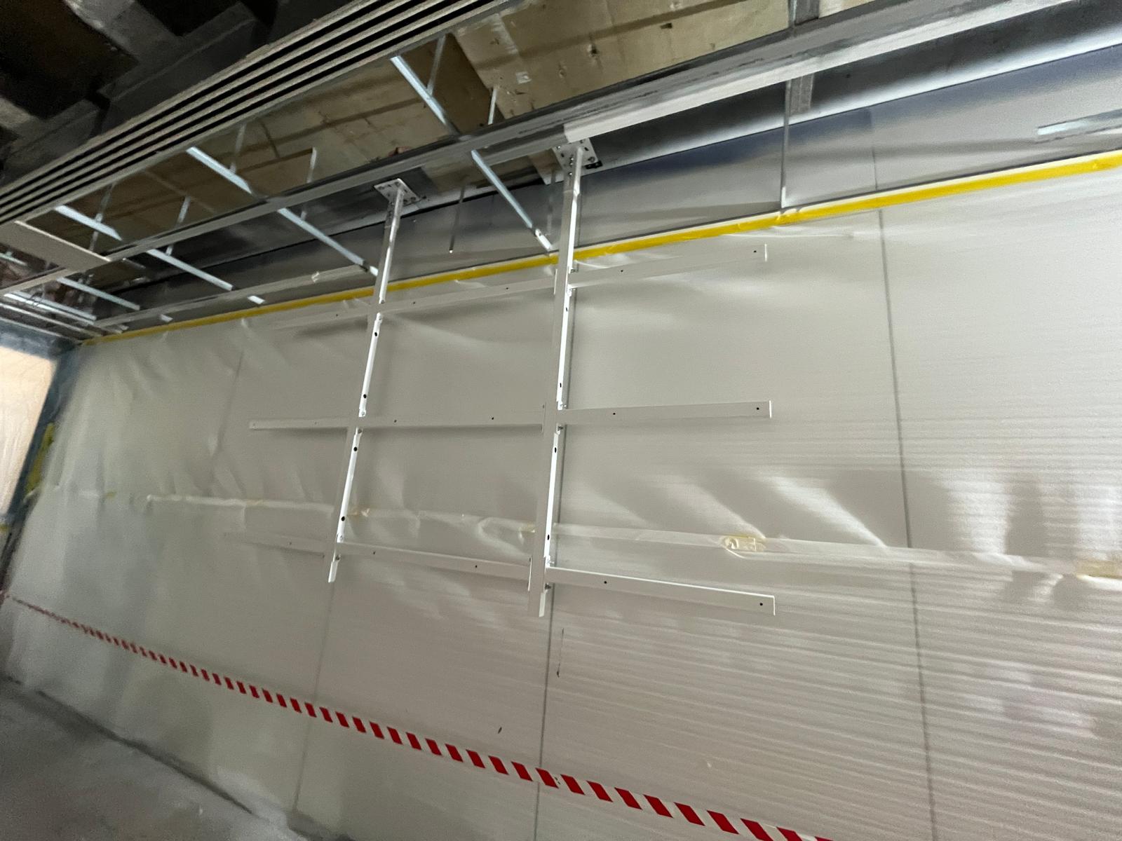 Madrid — horizontal substructure rails fixed to wall lining ahead of bracket install