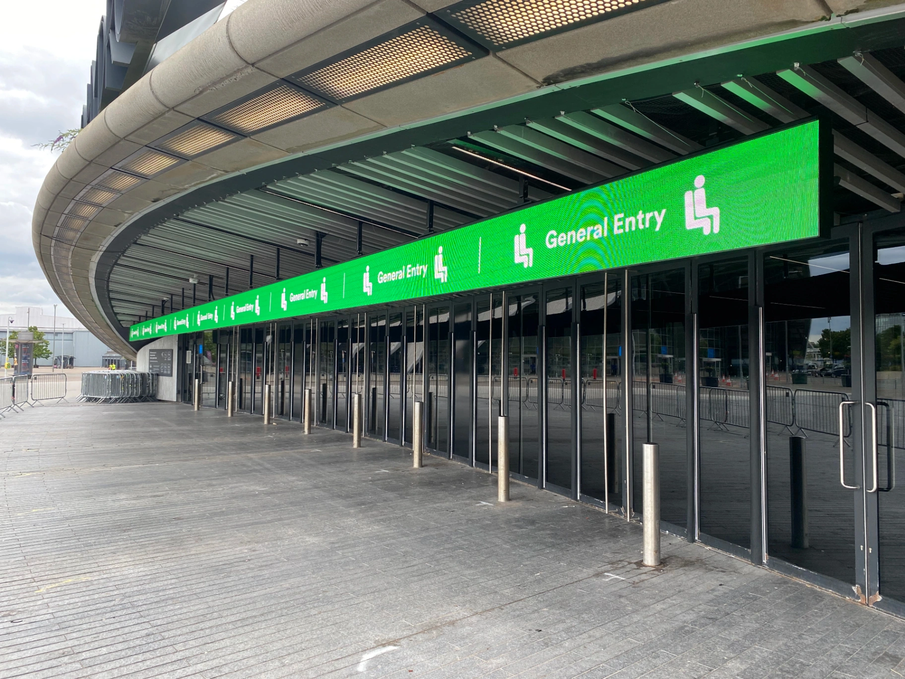 The OVO Hydro — full-length LED wayfinding banner above general entry concourse