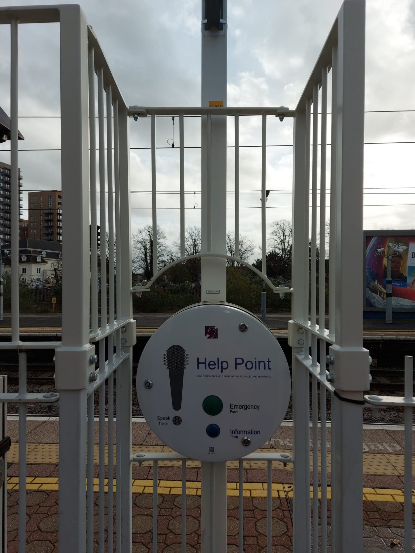 Railway Safety Barrier — barrier system integrated around platform Help Point with brackets and fixings