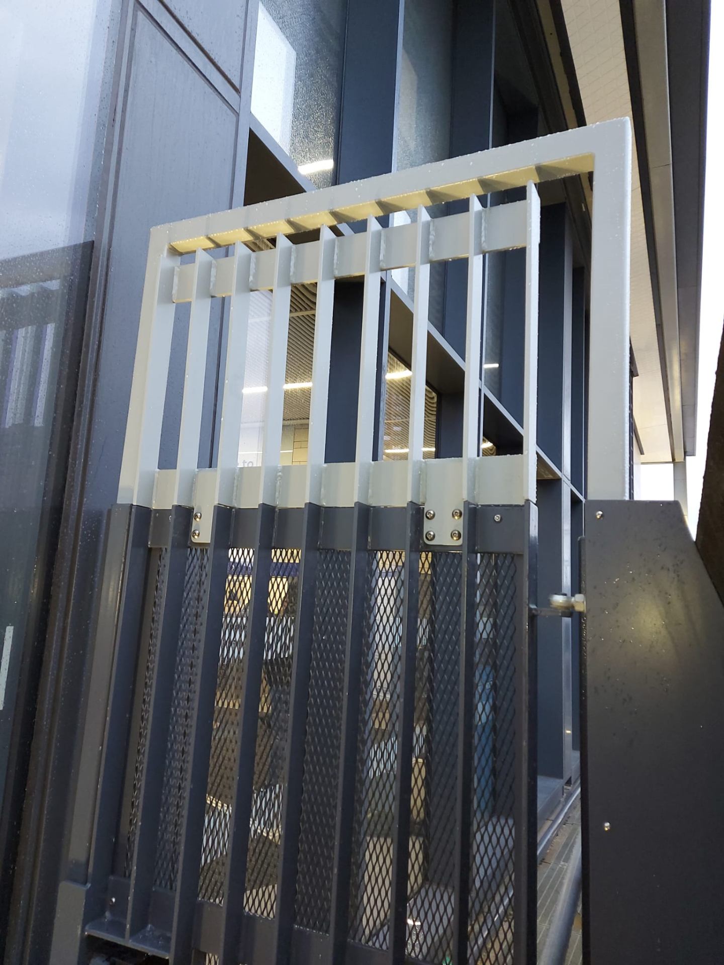 Railway Safety Barrier — bar-top with expanded-mesh infill panel, bolted joint detail at platform edge