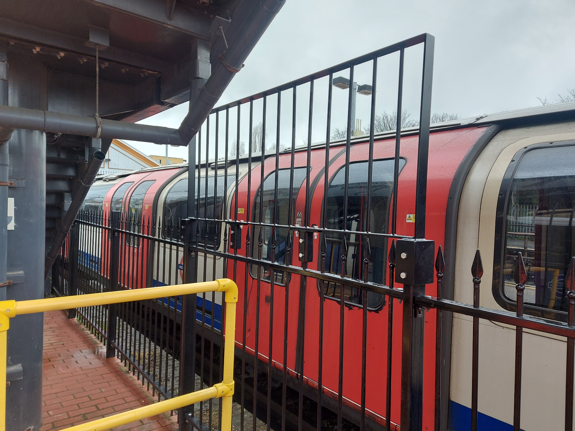 Railway Safety Barrier — spear-top trackside fencing installed alongside live London Underground stock