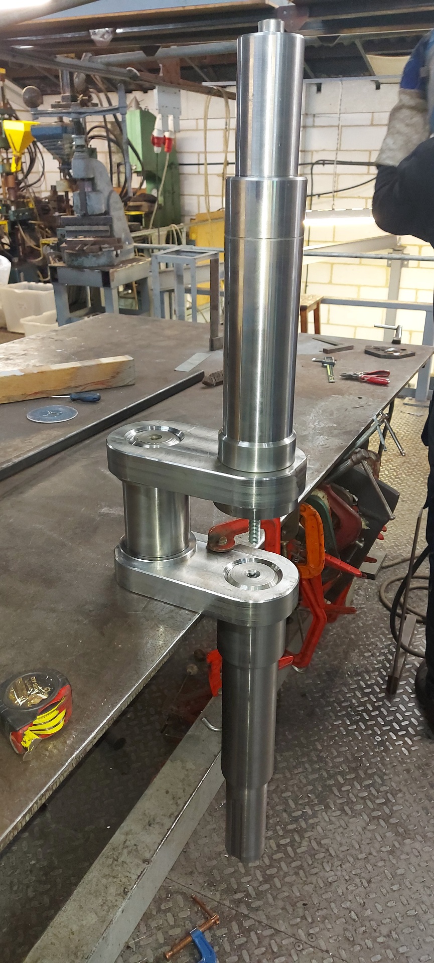 Sewer Barrier — bespoke machined spindle and linkage plate stack on the bench prior to assembly