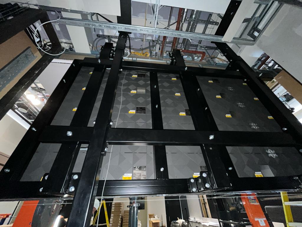 Schroders — panel array fixed back to bespoke welded sub-frame, low-angle install view