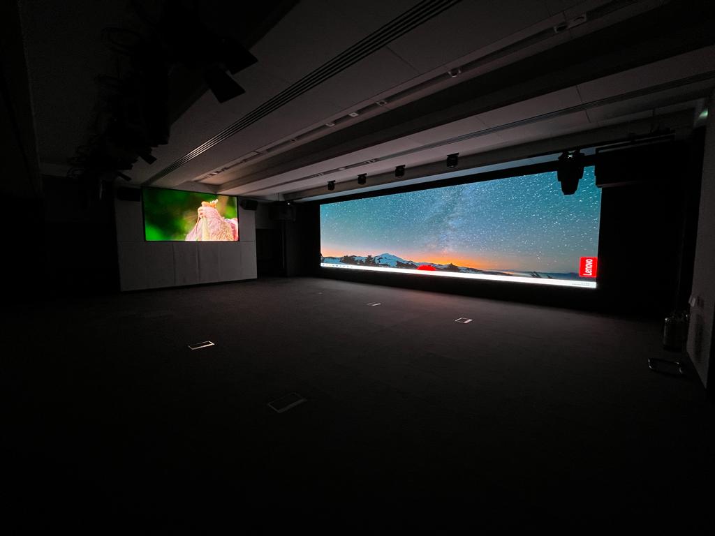 Schroders — finished room context, primary and secondary screens lit and calibrated in operational environment