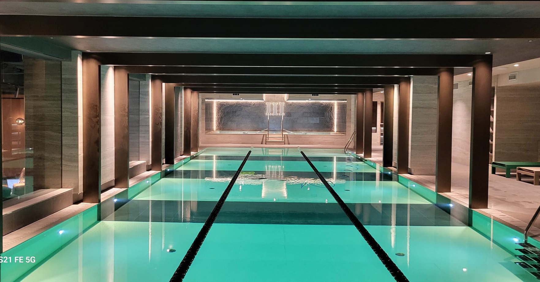 Third Space — finished 25m luxury pool with stone-clad columns, recessed lighting and engineered aluminium handrails, in operational service